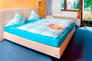 a bed with a blue comforter and blue pillows at Sleep and Go in Minden