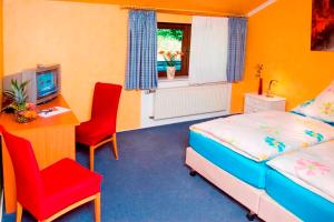 a bedroom with a bed and a desk and a television at Sleep and Go in Minden