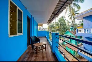 a blue balcony with a chair and a table at RAIAl DWELLING PLACE in Calangute