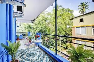 a balcony with a table and chairs and trees at RAIAl DWELLING PLACE in Calangute