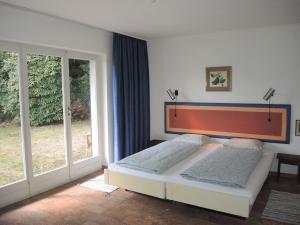 a bedroom with a bed and a large window at La Civetta by Fewotessin in Brissago +50 photos