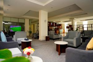a lobby with couches and chairs and a television at فندق براي Brai Hotel in Ad Dawādimī
