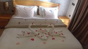 a bed with two towels in the shape of elephants at Appart-Hotel SOFINES in Agadir +41 photos