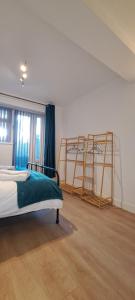 a bedroom with a bed and a ladder at Ground Floor Apartment, Garden and free parking - 10 The Rise in Kirkstall