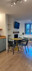 a living room with a table and two chairs at Ground Floor Apartment, Garden and free parking - 10 The Rise in Kirkstall