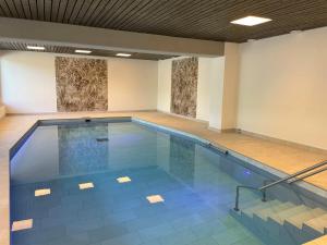 an empty swimming pool in a building at Portofino by Fewotessin in Brissago