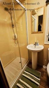a bathroom with a shower and a sink at Park Dean Resorts Premium plot with Mountain view & Decking in Abergele +13 photos