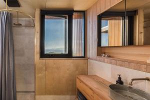 a bathroom with a sink and a window at Native Dog Cabin in Bremer Bay +39 photos