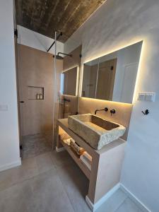 a bathroom with a large sink and a shower at Sunset Guesthouse - Costa Vicentina in Aljezur +19 photos
