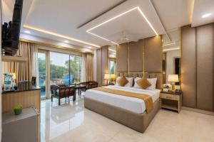 a hotel room with a bed and a desk at Hotel Downtown by Quadis - East of Kailash in New Delhi +97 photos