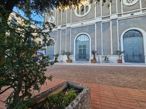 a building with two blue doors and a courtyard at Olimpo Caserta in Caserta