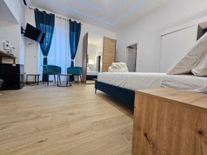 a bedroom with a bed and a living room at Olimpo Caserta in Caserta