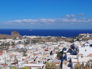 a city with white buildings and the ocean at Bright in Agaete
