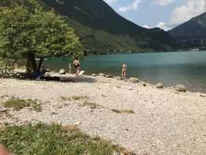 a group of people standing on the shore of a lake at Locazione da nonna Gusta in Vittorio Veneto