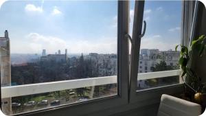 a window with a view of a city at Grande chambre de 16m2 in La Croix Rousse