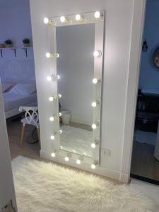 a mirror with lights on it in a room at White House in Madinaty