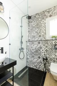 a bathroom with a glass shower and a toilet at White House in Madinaty
