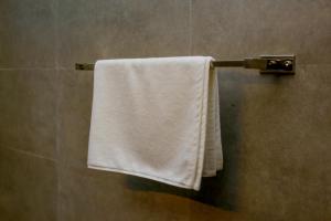 a white towel hanging on a towel rack in a bathroom at Ayana Resort Wilpattu in Wilpattu