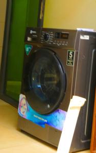 a washing machine sitting on top of a counter at KIGALI QUEENs HOME AND APARTMENT in Kigali