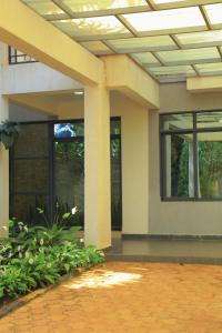a building with a ceiling with windows and plants at KIGALI QUEENs HOME AND APARTMENT in Kigali