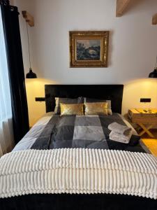 a bedroom with a large bed with a picture on the wall at Villa Podhalańska 1959 in Biały Dunajec