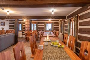a dining room with a wooden table and chairs at Štepánka - Chalet & SPA in Benecko