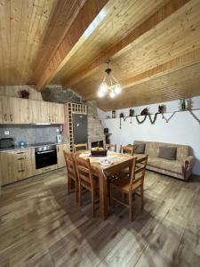 a kitchen and dining room with a table and chairs at Cantinho da Aldeia in Castedo +20 photos