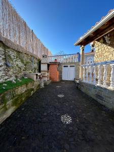 a courtyard of a stone building with a garage at Cantinho da Aldeia in Castedo