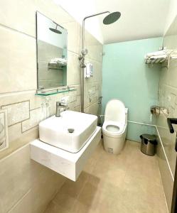 a bathroom with a sink and a toilet at LAKSHMI Apartment & Hotel Da Nang in Danang +10 photos