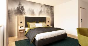 a bedroom with a large bed with a green rug at Wohlfühlhotel zur Grässelmühle in Sasbach in der Ortenau