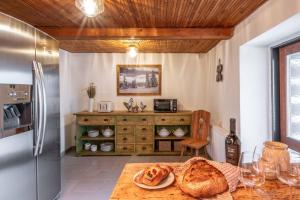 a kitchen with a table with a loaf of bread on it at Štepánka - Chalet & SPA in Benecko +13 photos