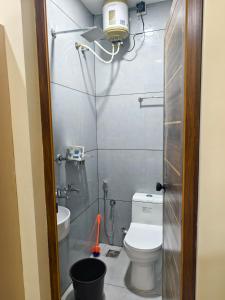 a small bathroom with a toilet and a sink at C K Residency in Cochin