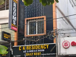 a sign on the side of a building with a window at C K Residency in Cochin
