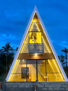 a pyramid house with a balcony on top of it at Celebrations Party House in Kolhapur