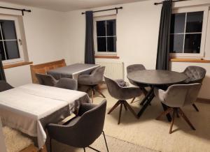 a room with a table and chairs and a table and a bed at Family & Friends in Hopfgarten im Brixental +8 photos
