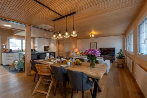 a dining room and living room with a table and chairs at Ganzes Haus am Bodensee in den Bergen im Appenzell in Heiden