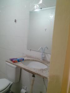 a bathroom with a toilet and a sink at kitnet A in São Luís
