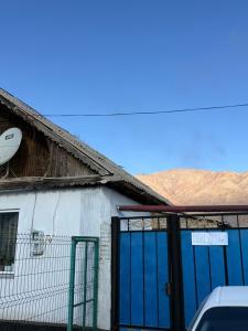 a building with blue garage doors with a satellite at Don-Talaa Guest House in Döng-Talaa