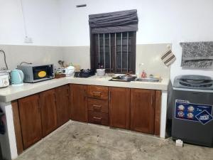 a kitchen with a sink and a stove at Seven S villa in Kamburugamuwa