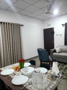 a table with plates and flowers on it in a room at Seven S villa in Kamburugamuwa