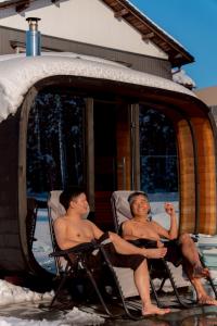 two men sitting in lawn chairs in the snow at HAYU Hearth Yuzawa in Yuzawa +38 photos