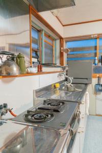a kitchen with a stove top oven in a kitchen at HAYU Hearth Yuzawa in Yuzawa