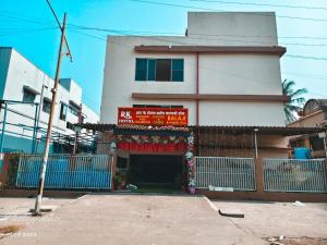 a building with a sign in front of it at RK Hotel in Boisar