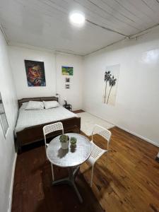 a bedroom with a bed and a table and chairs at Casa Mirador Pichilemu in Pichilemu