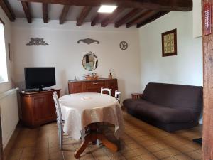 a living room with a table and a couch at LA Chataigne in Santranges