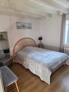 a bedroom with a large bed with a blue blanket at LA Chataigne in Santranges