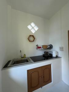 a kitchen with a sink and a counter top at Spiral Resort in Ko Phayam +74 photos