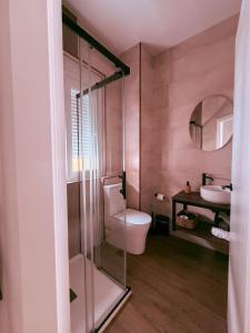 a bathroom with a toilet and a sink at La Banda Suites in Seville +97 photos