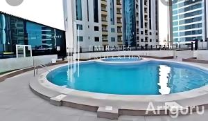 a hot tub on the roof of a building at Orient Tower in Ajman 
