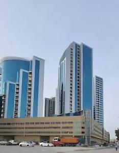 a group of tall buildings in a city at Orient Tower in Ajman 